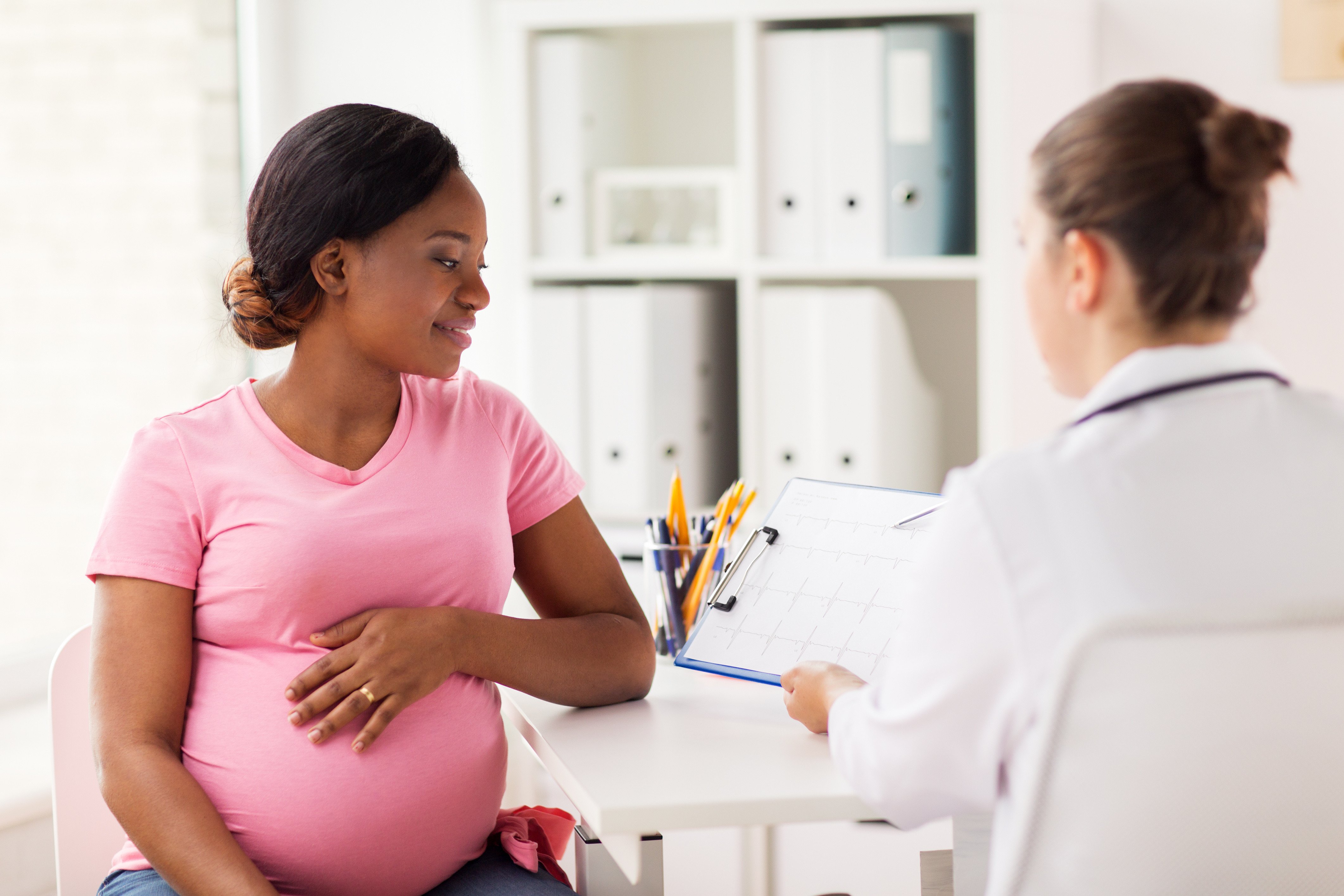 Pregnant woman speaking with doctor