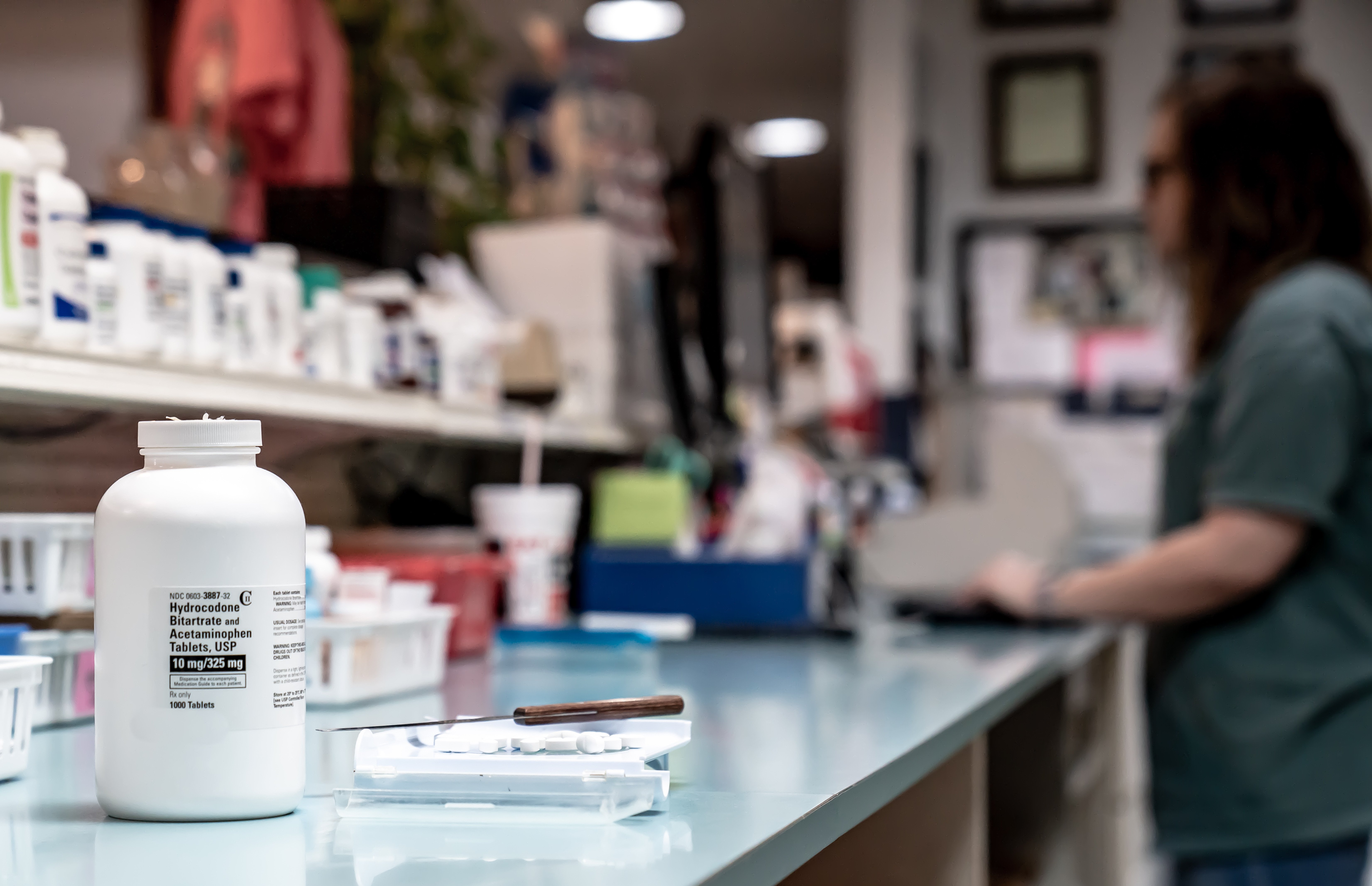 Pill bottle with person in the background