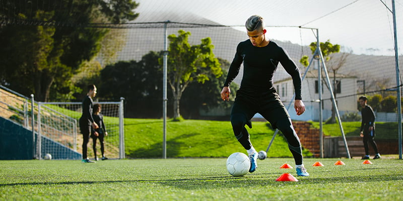 Soccer player dribbling at training session.