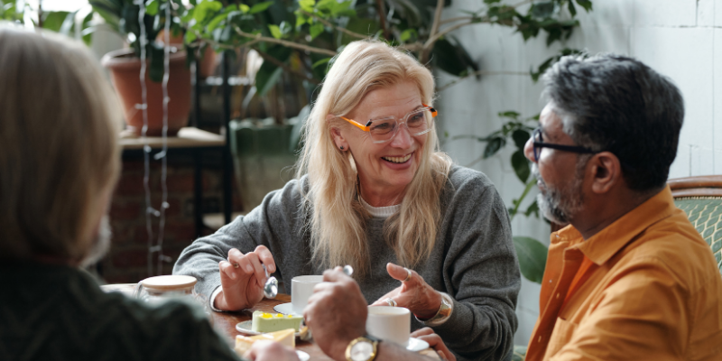 Friends talking and listening to one another in a restaurant