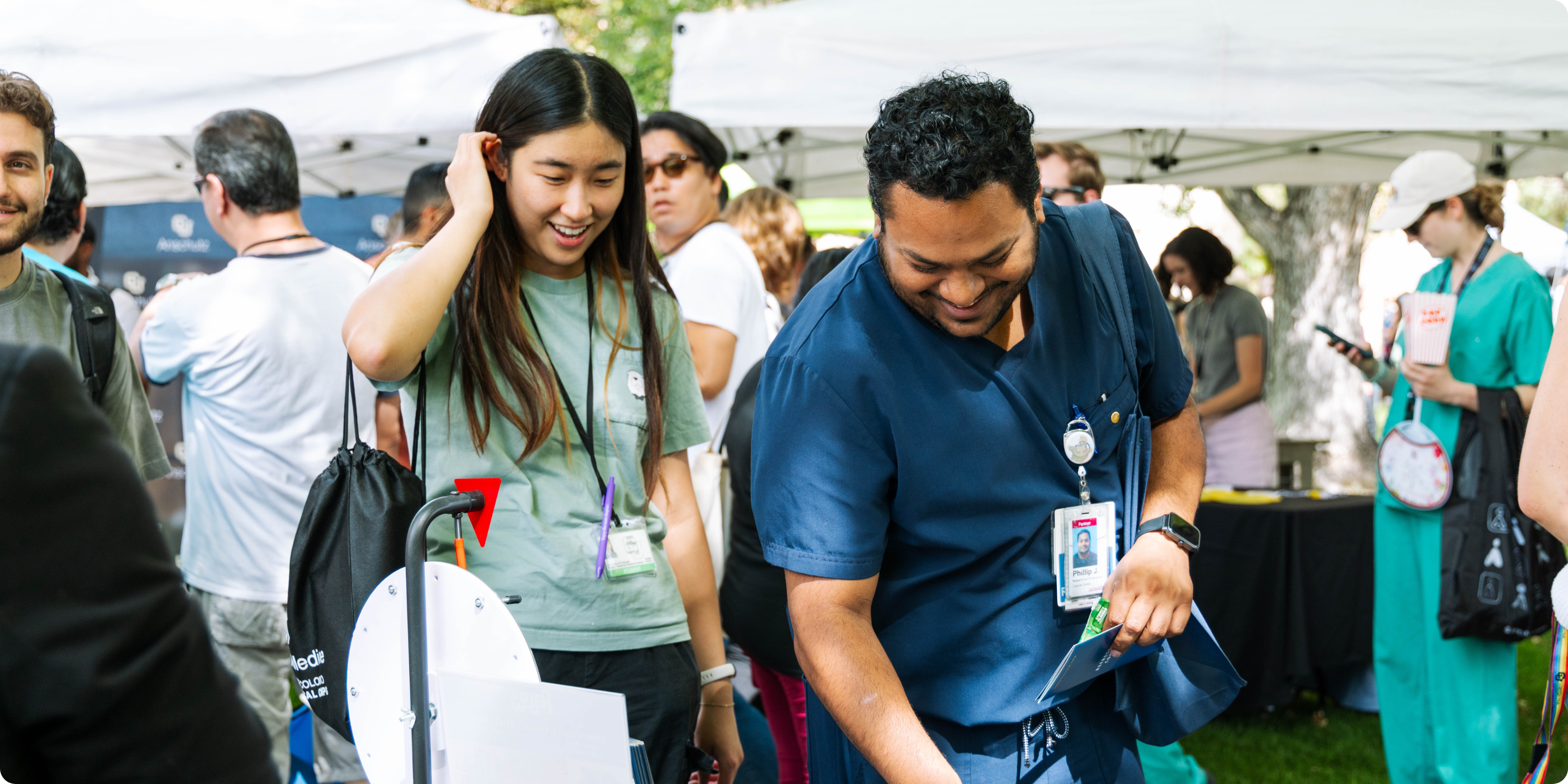Two people checking out a booth at the CU Anschutz Block Party