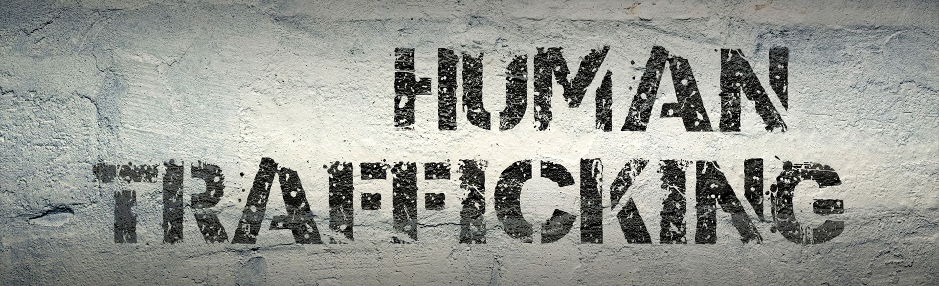 Human Trafficking wording on brick wall