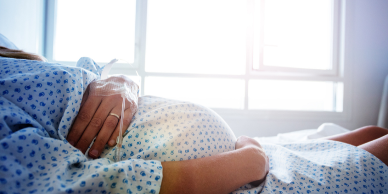 pregnant woman laying in a hospital bed