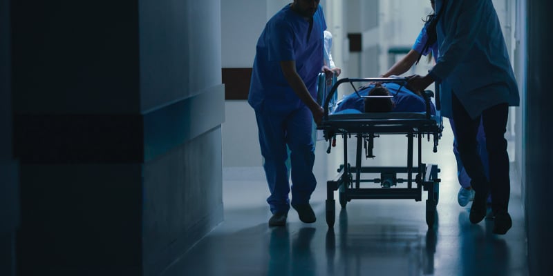 two nurses with a patient in the er