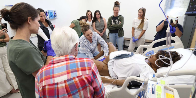 nurses around a simulation scenario 