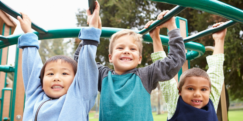 three children on a jungle gym