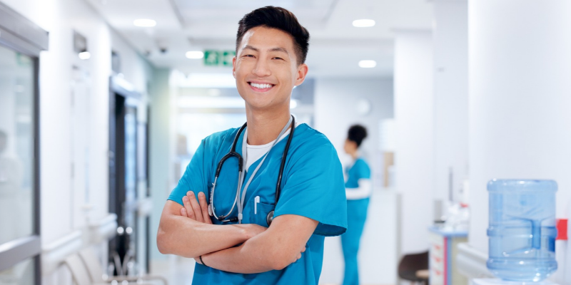 male nurse with arms crossed and smiling 
