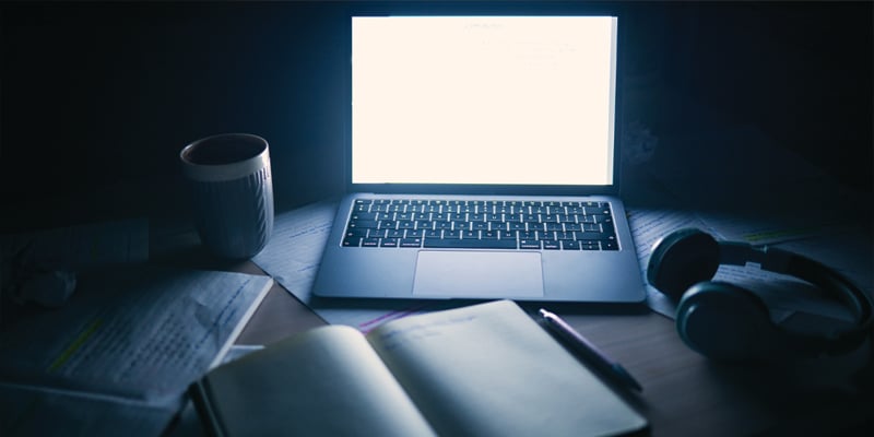 computer and notebook in the dark