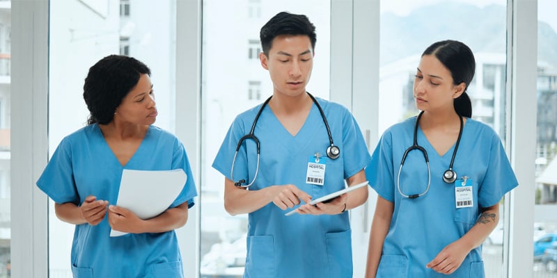 three nurses walking in a hospital