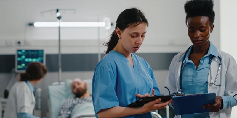two nurses talking in a hospital room