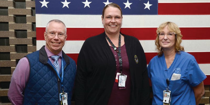 Milwaukee VA Medical Center Executive Director Jim McLain, left, stands with Milwaukee VA Employee of the Year Erika Hernandez, center, and ICARE Champion of the Year Deanna Simcakoski-Carleton.