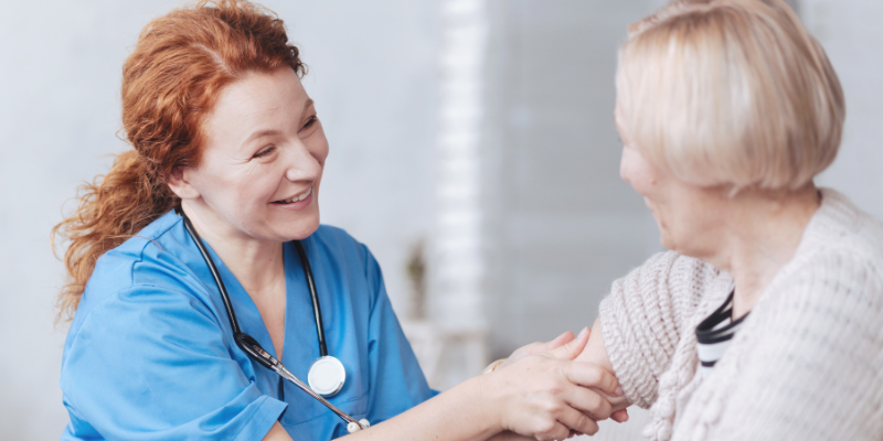 nurse practitioner helps an older woman