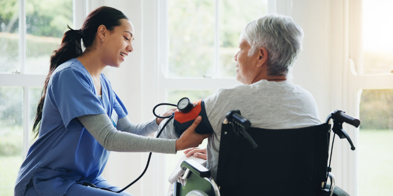nurse helps patient in wheelchair