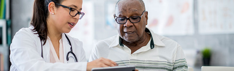 Older patient speaking with physician