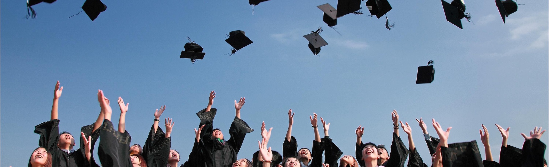 Graduates throwing their caps in the air