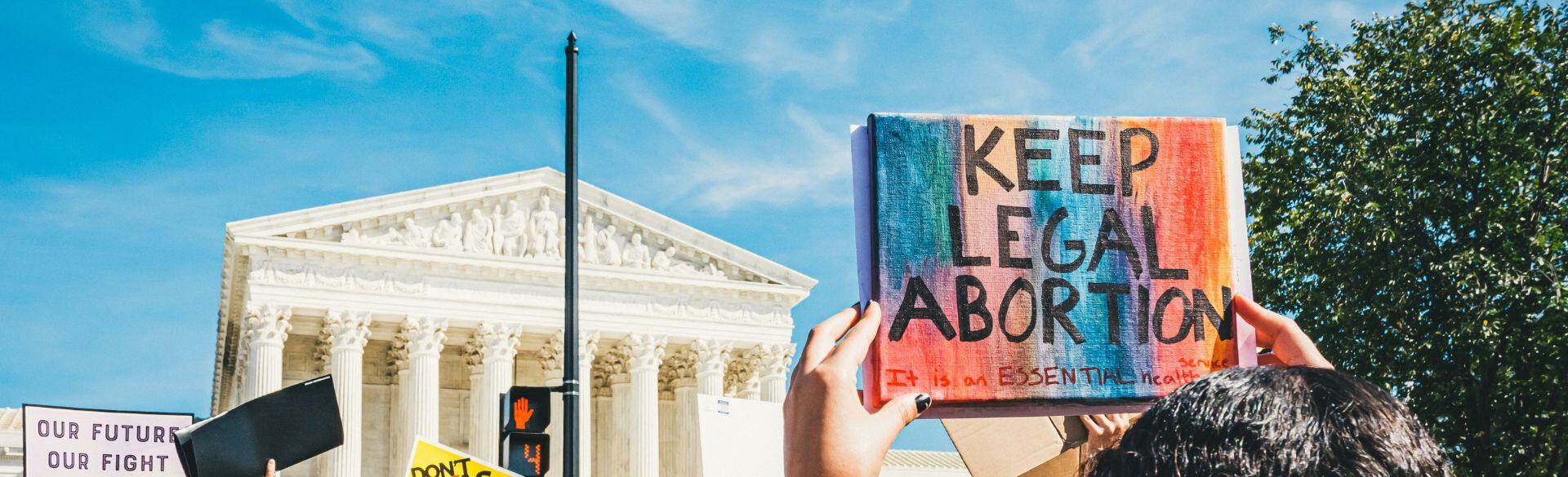 Keep Legal Abortion sign being held in front of capital building