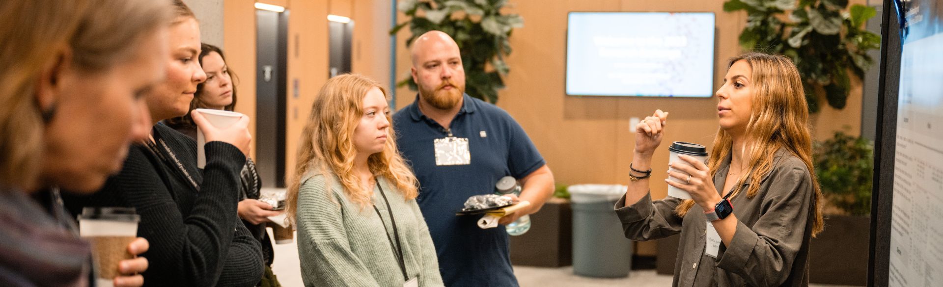 Folks discussing research in front of poster