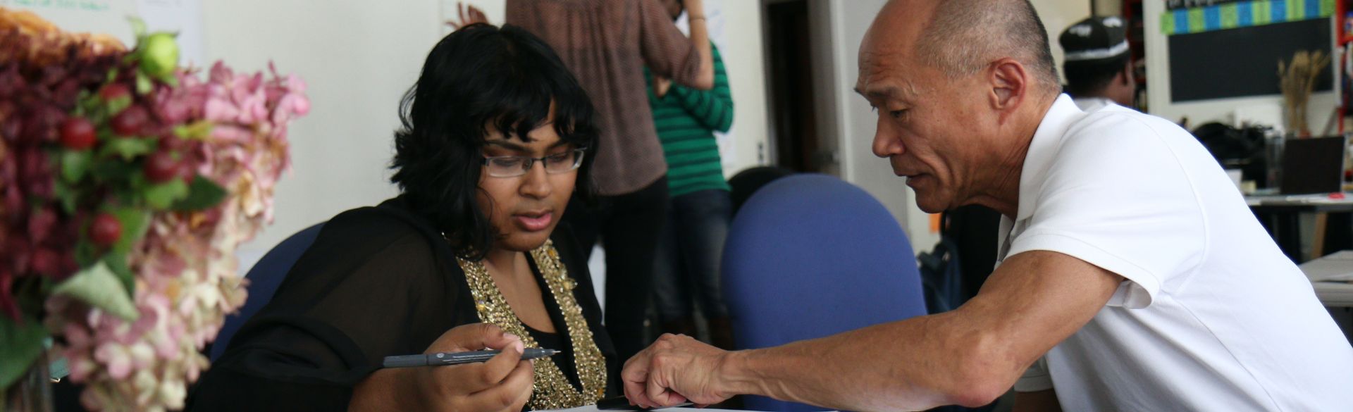 Older man mentoring women with math