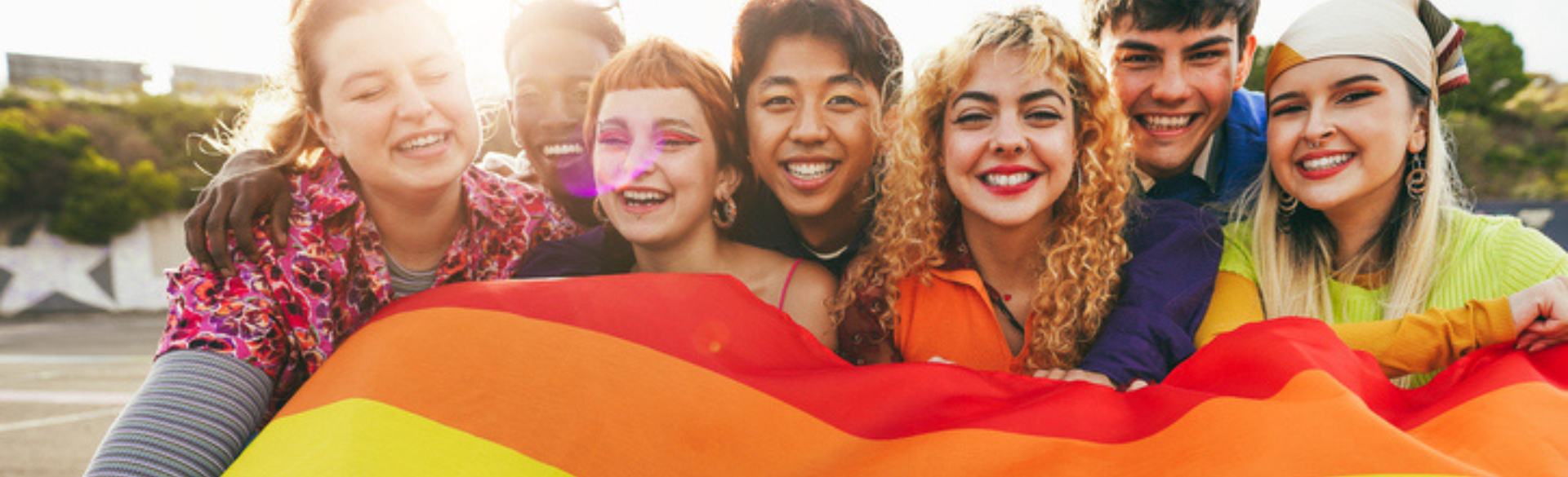 6 young adults with pride flag