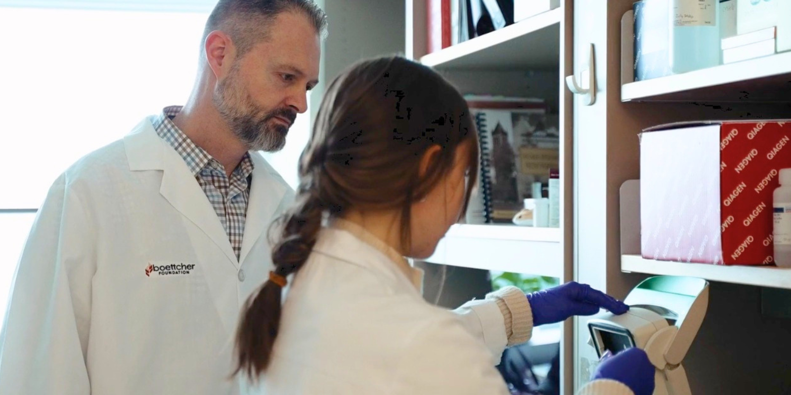 James Costello, PhD, works with a colleagues in his lab.