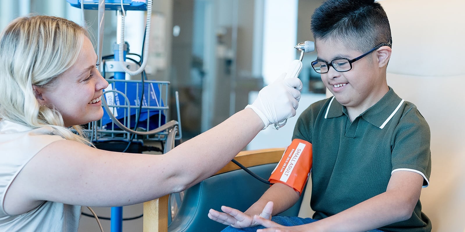 Clinical coordinator taking the vitals of a research participant with Down syndrome
