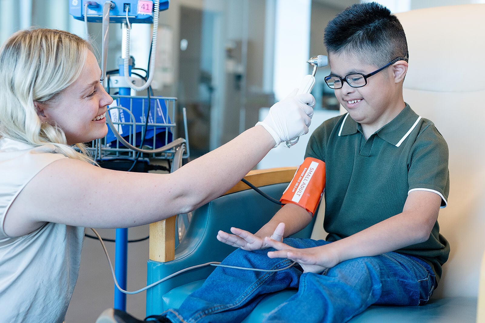 Clinical coordinator taking a research participant's temperature and blood pressure