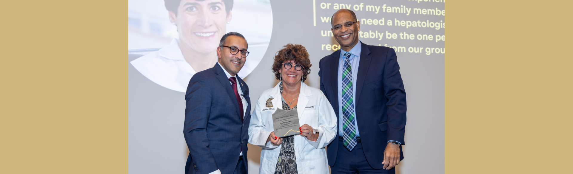 Lisa Forman, MD, pictured center, smiles as she is inducted into the 2024 Department of Medicine Clinical Excellence Society.