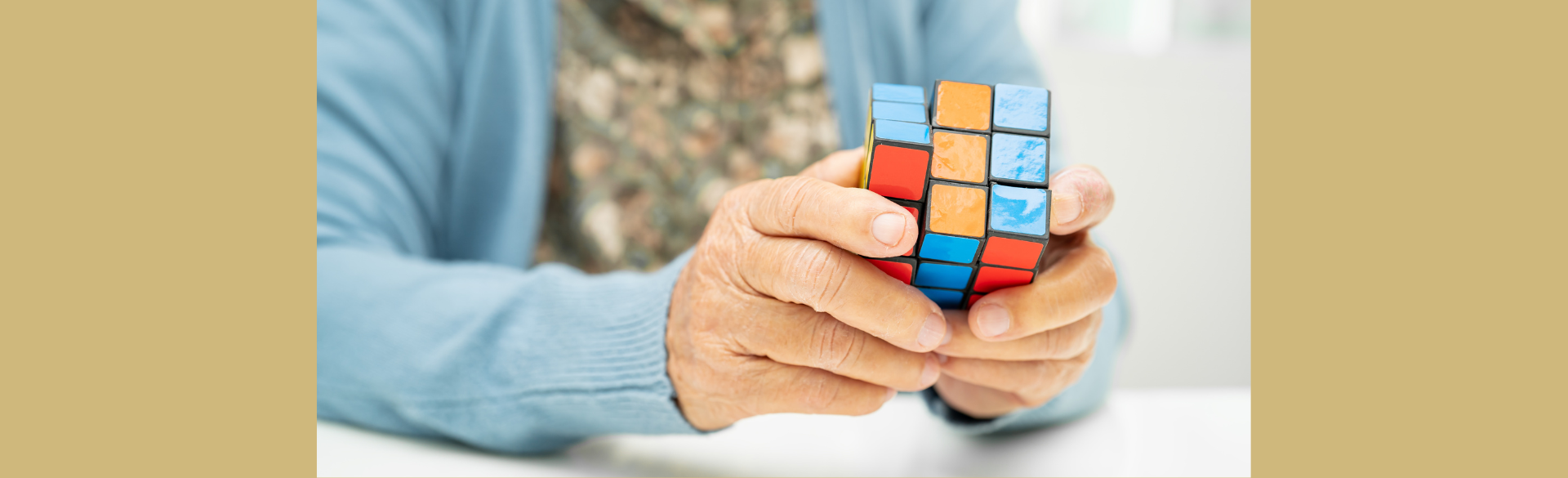 Image of an older adult holding a Rubik's Cube.