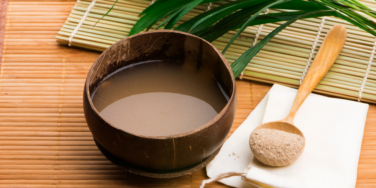 A drink containing kava sits on a table.