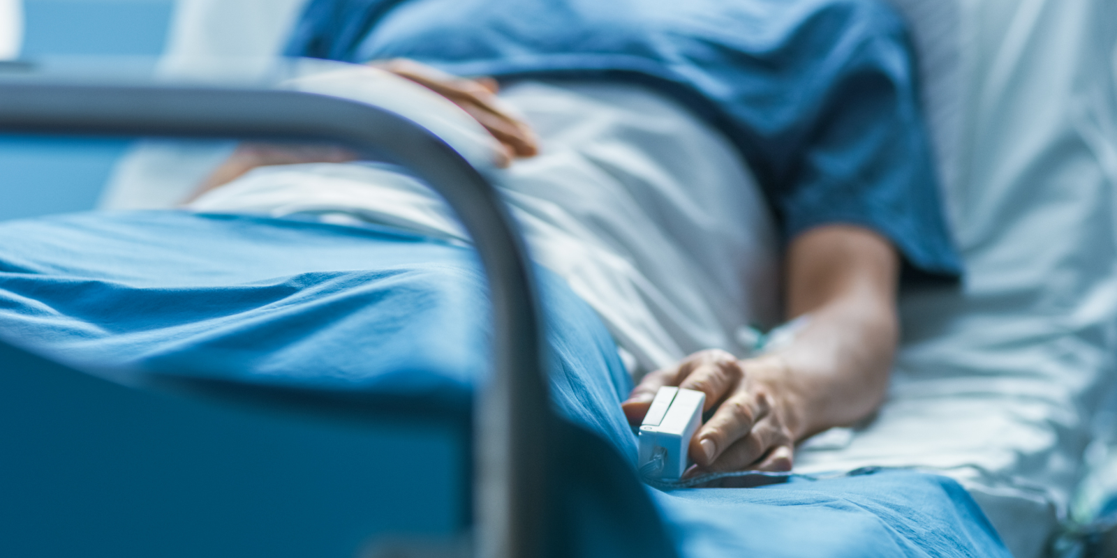 A person laying in a hospital bed.