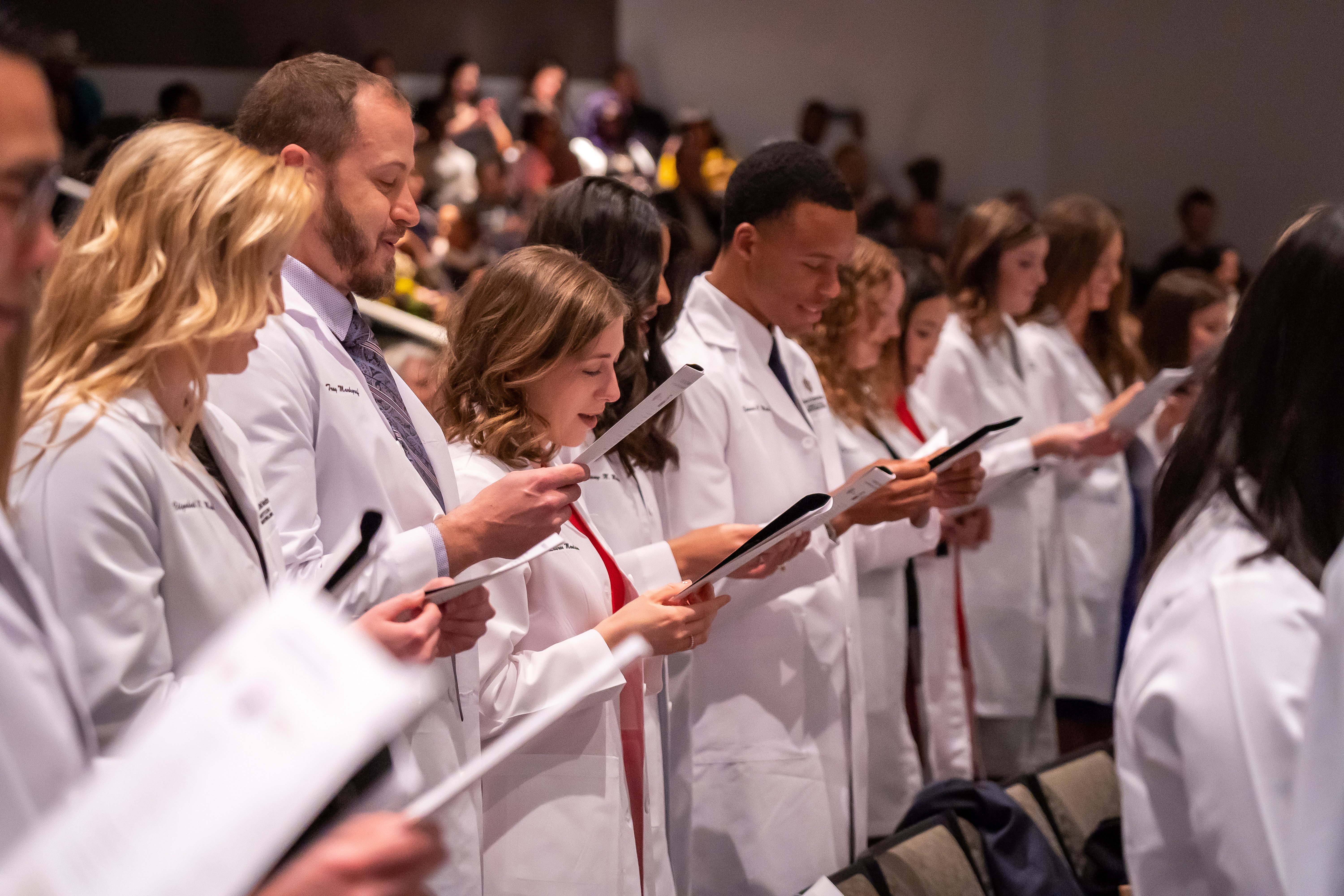 students read the dental oath during their white coat ceremony