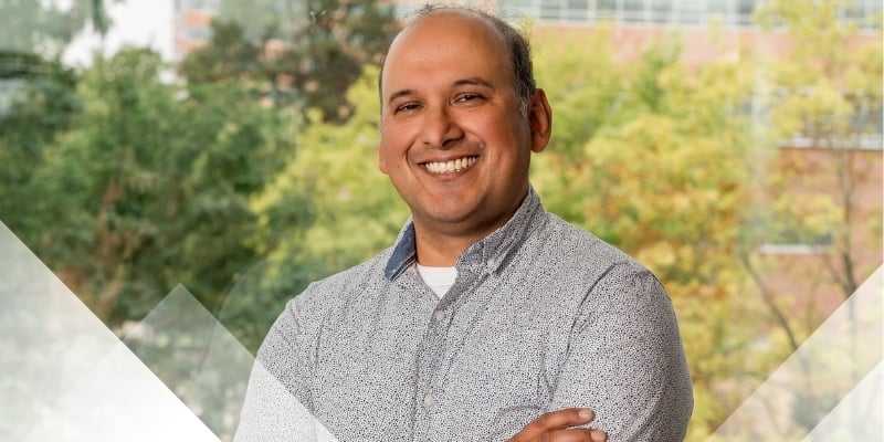 Debashis smiles with arms folded