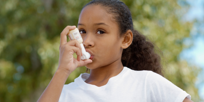 Young girl using an inhaler
