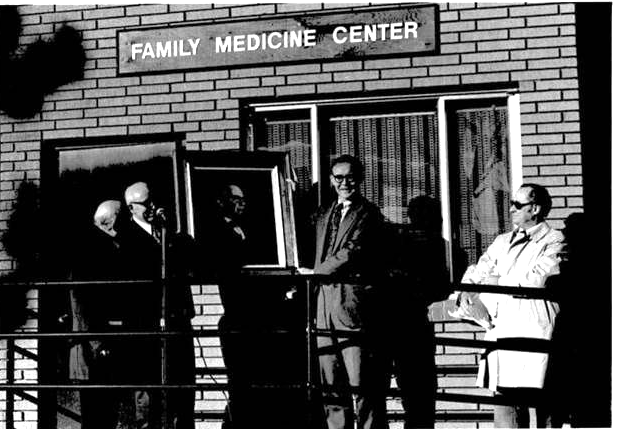 Black and white photo of Family Medicine leaders in front of one of the Department's first building.