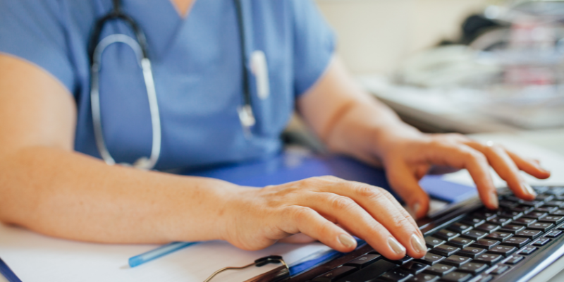 Nurse typing on a keyboard.