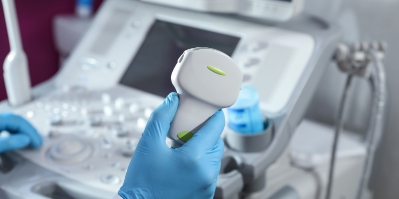 Doctor holding an ultrasound tool.