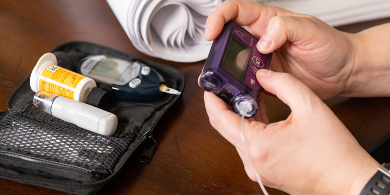 Person holding diabetes care tools