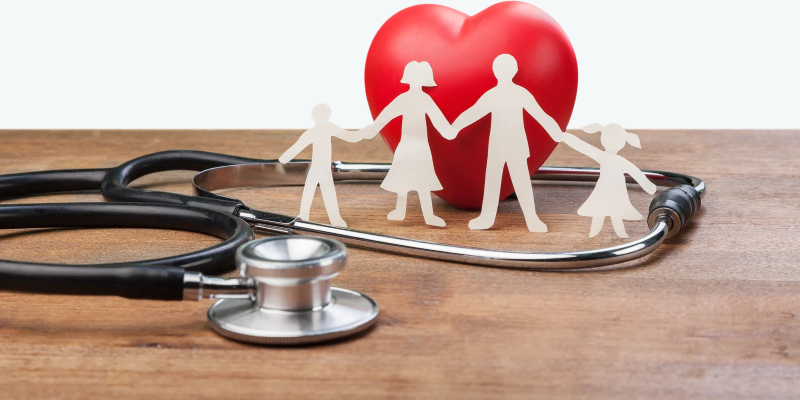 Stethoscope around a paper family and heart.