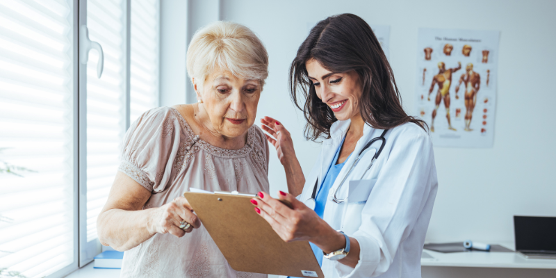 Dr. and patient both looking at a clip board