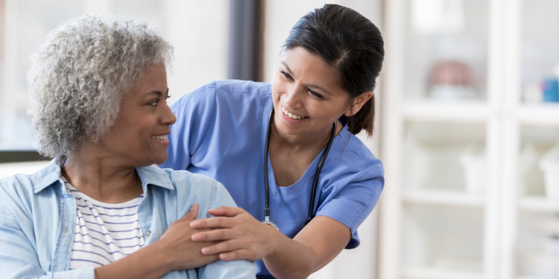 Dr. comforting and smiling at a patient.