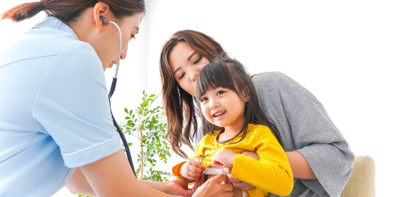 Dr. listening to pediatric patient's heart 