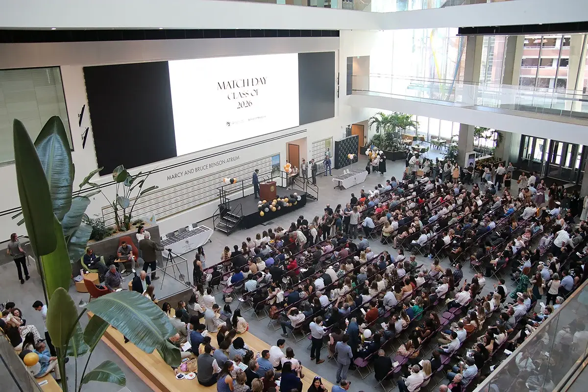 Sky view of room full of students and family sitting for Match Day ceremony.