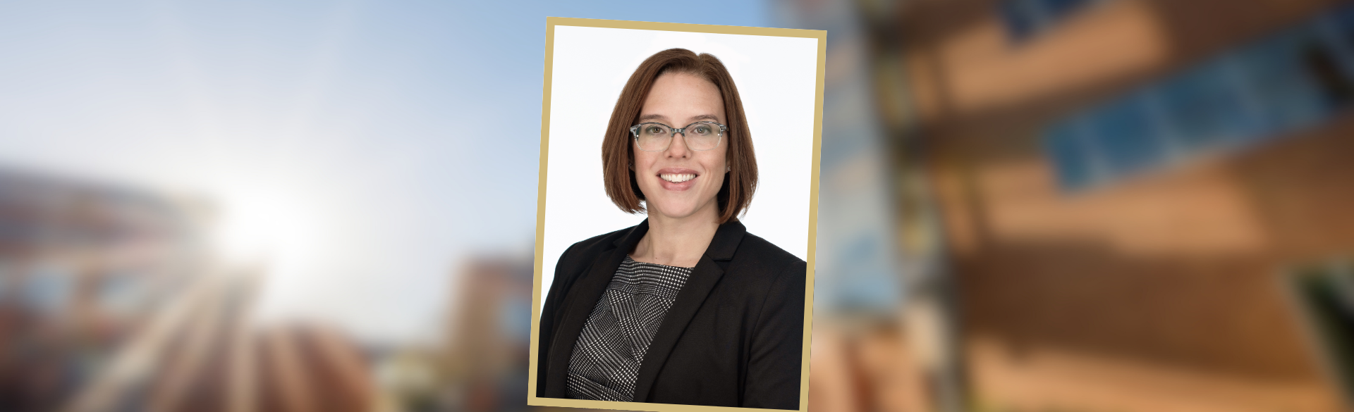 A portrait of Lynn Hassman, MD, PhD, center against a blurred background of the CU Anschutz Medical Campus