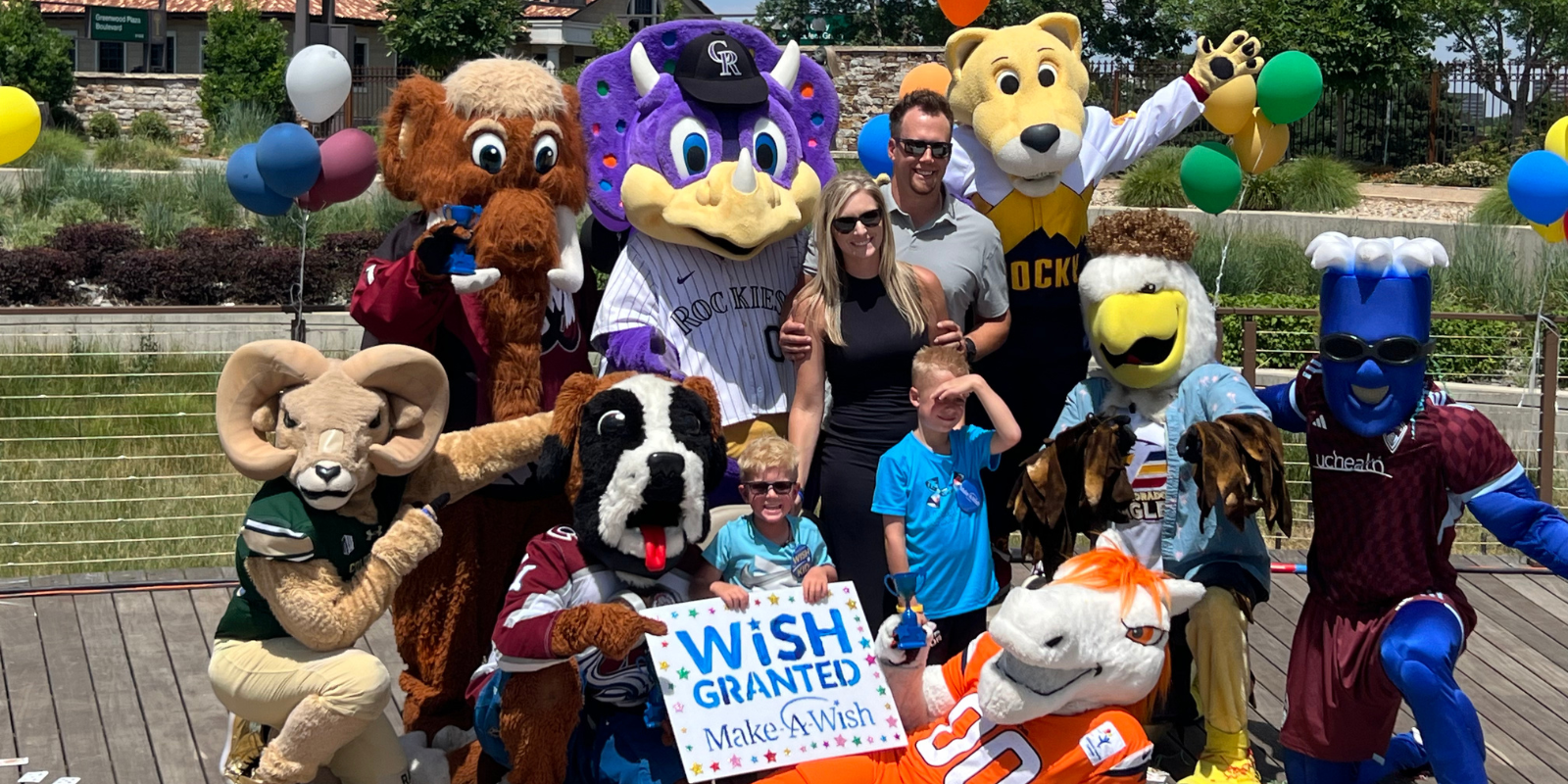 Christian Helfrich and his family pose for a photo with Colorado mascots.