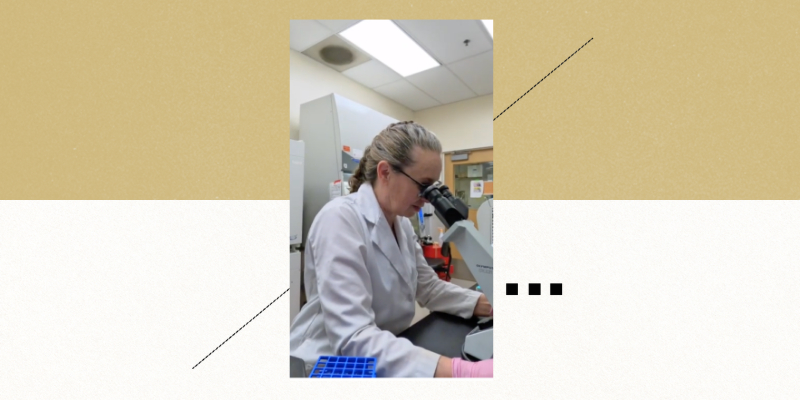 Patricia Ernst, PhD, looking through microscope | University of Colorado Anschutz Cancer Center