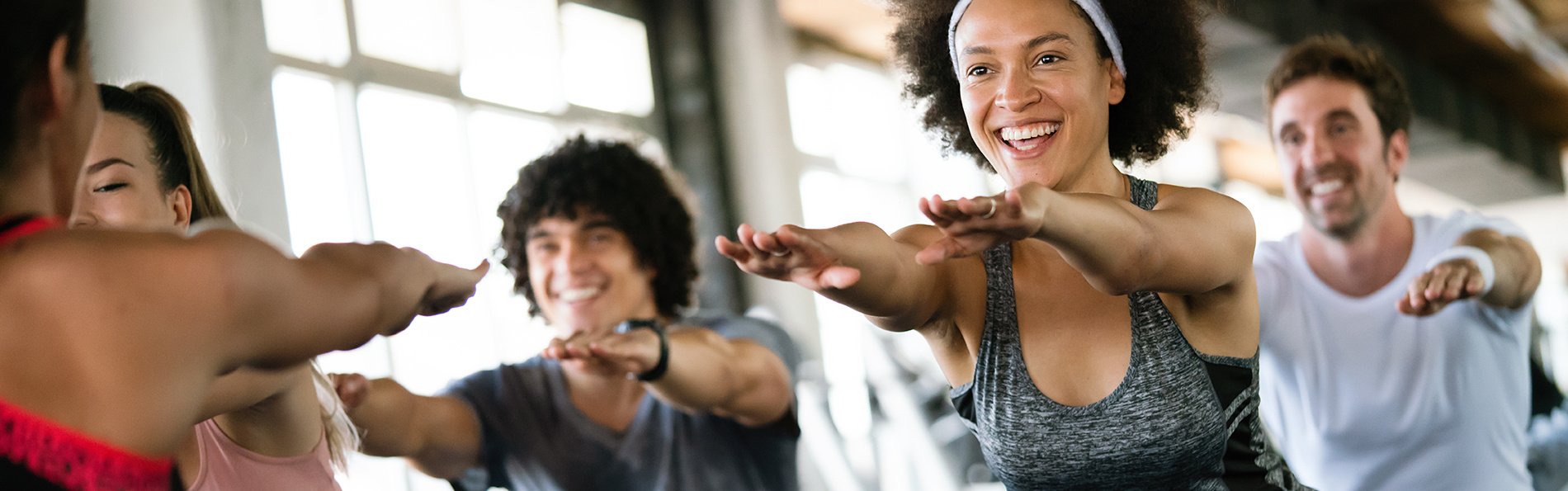 People working out in a fitness class at a gym. 