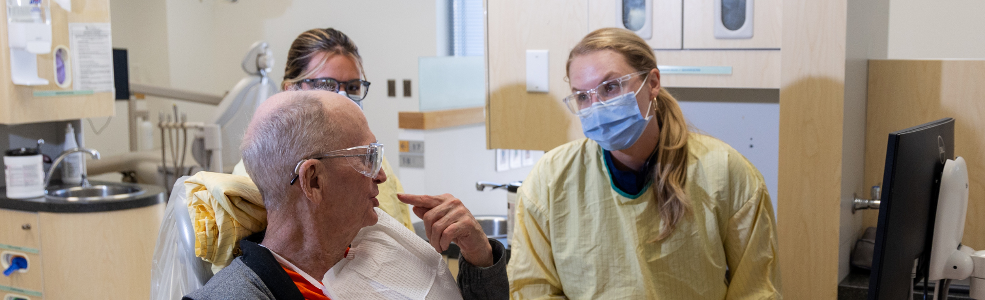 dental student and older adult patient in clinic 