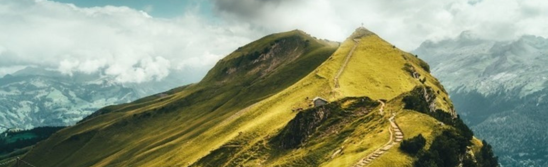 Image of a windy path on a green mountain