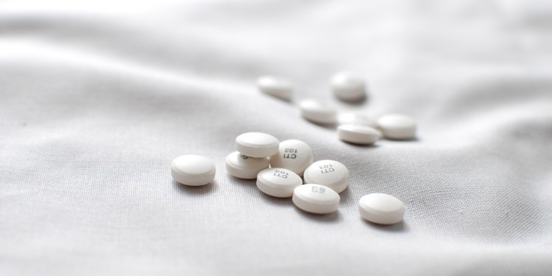 White pills on white fabric