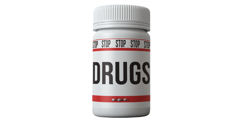 Pill bottle with the word "DRUGS" written on it